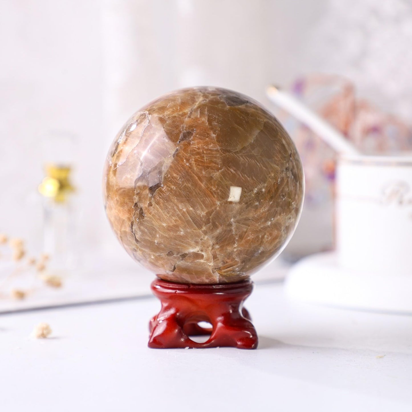 Nupuyai Natural Orange Moonstone Crystal Ball with Resin Stand, Healing Crystal Sphere for Home Decor 2.4"-2.76"(61mm-70mm)